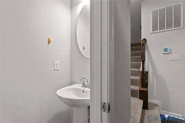 a bathroom with a sink and mirror