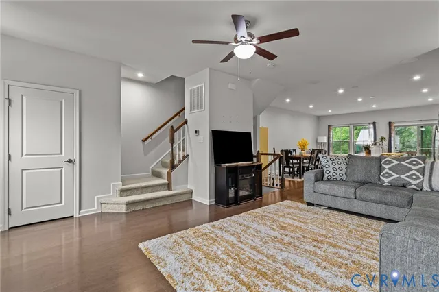 a living room with fireplace furniture and a flat screen tv