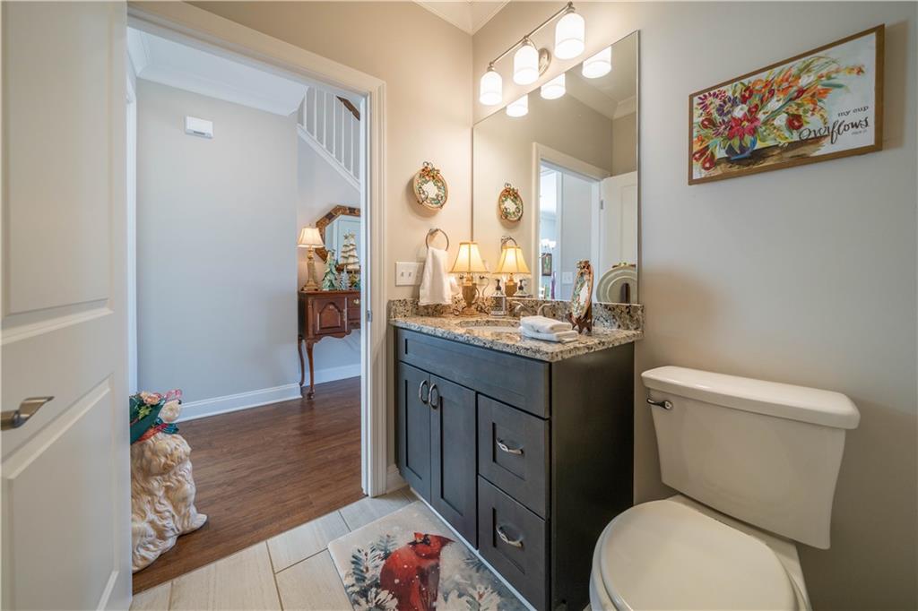 32 Encore Lane Cartersville, GA 30120 - Photo 19 of 28 a bathroom with a granite countertop toilet a sink and a mirror