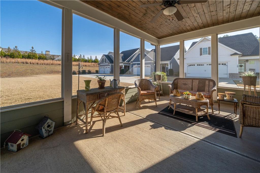 32 Encore Lane Cartersville, GA 30120 - Photo 25 of 28 a living room with furniture a floor to ceiling window and a flat screen tv