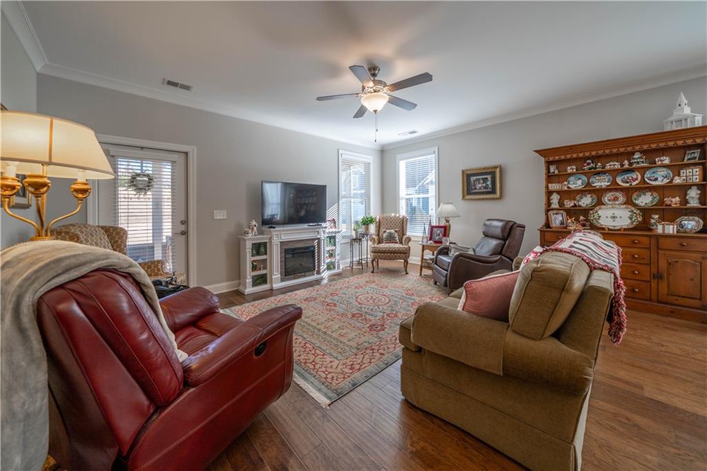 32 Encore Lane Cartersville, GA 30120 - Photo 5 of 28 a living room with furniture a ceiling fan and a flat screen tv