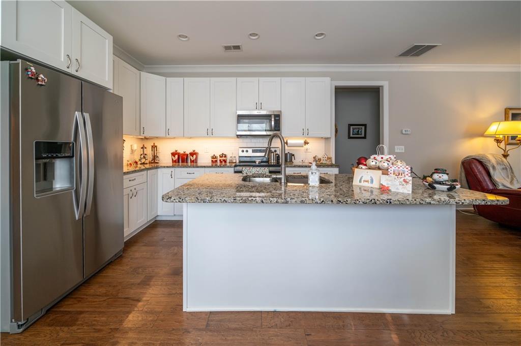 32 Encore Lane Cartersville, GA 30120 - Photo 7 of 28 a kitchen with granite countertop a refrigerator and microwave