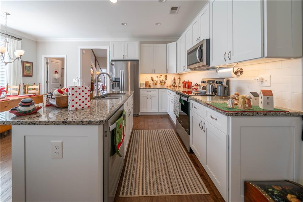 32 Encore Lane Cartersville, GA 30120 - Photo 8 of 28 a kitchen with granite countertop lots of counter top space and stainless steel appliances