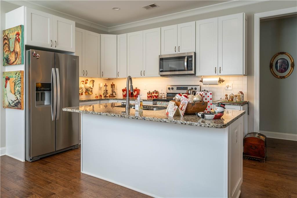 32 Encore Lane Cartersville, GA 30120 - Photo 10 of 28 a kitchen with stainless steel appliances granite countertop a refrigerator and a stove top oven
