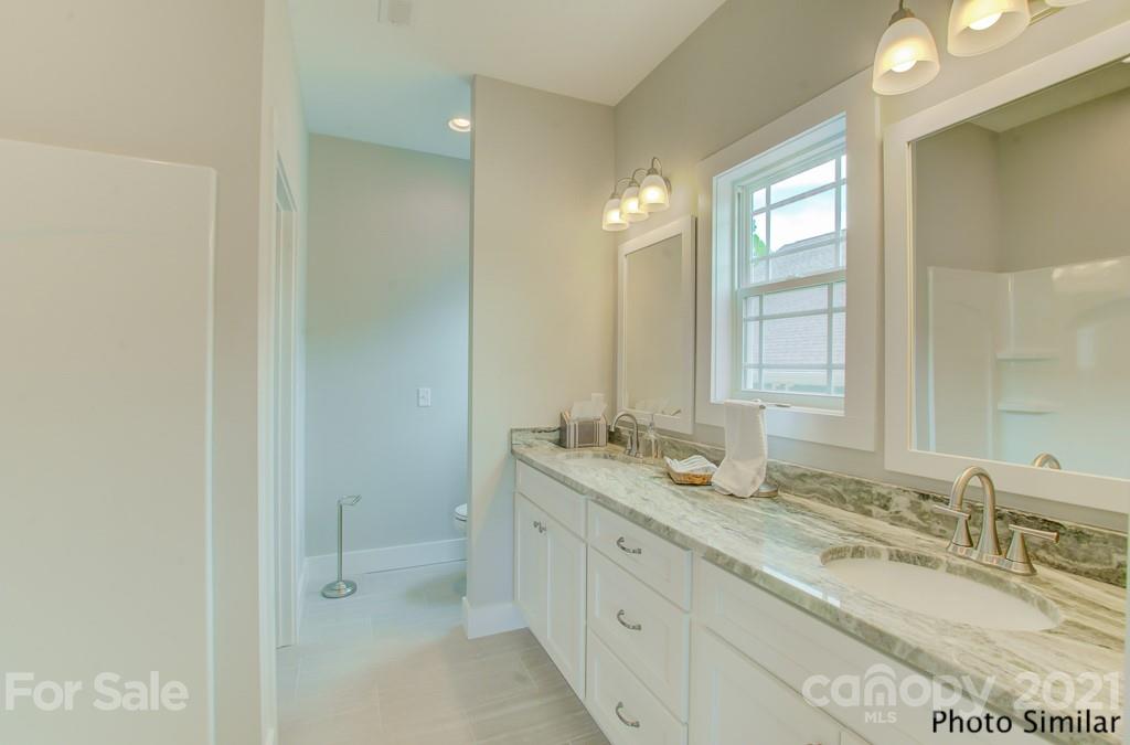 123 Hayes Rdg Lane, Unit 4 Mills River, NC 28759 - Photo 13 of 18 a bathroom with double sink and a mirror