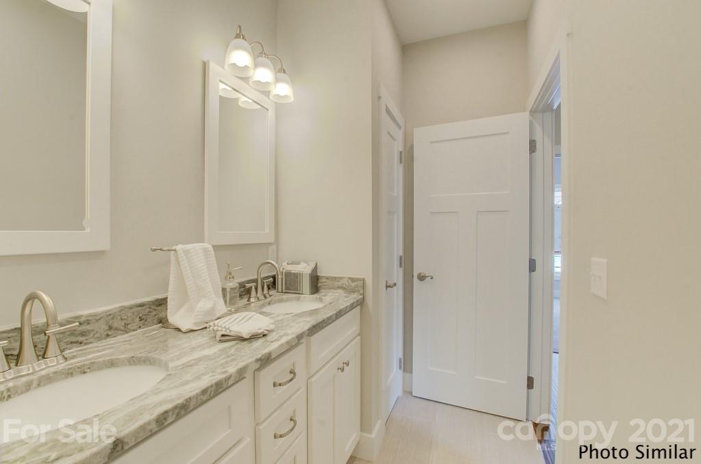 123 Hayes Rdg Lane, Unit 4 Mills River, NC 28759 - Photo 17 of 18 a bathroom with double vanity sink and a mirror