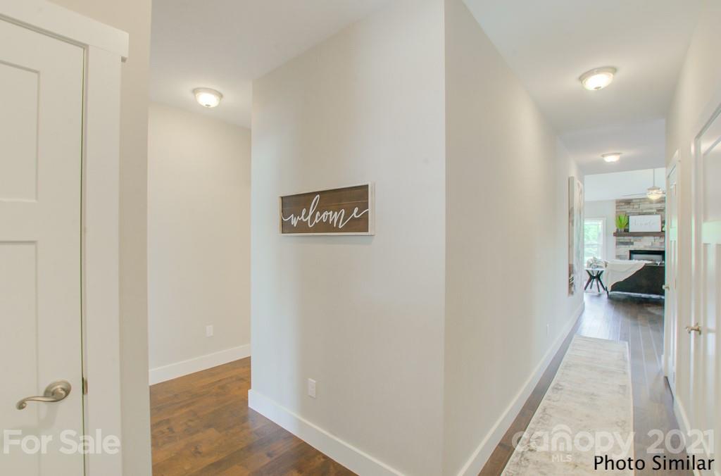 123 Hayes Rdg Lane, Unit 4 Mills River, NC 28759 - Photo 18 of 18 a view of a hallway with wooden floor and a bathroom