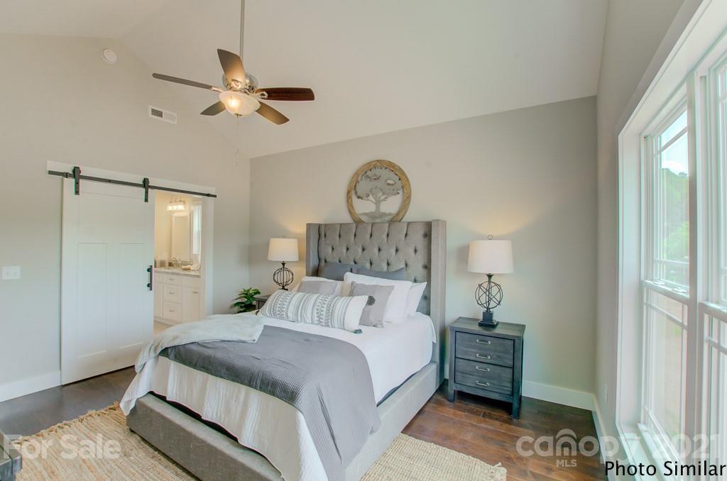 123 Hayes Rdg Lane, Unit 4 Mills River, NC 28759 - Photo 10 of 18 a bedroom with a bed and a chandelier