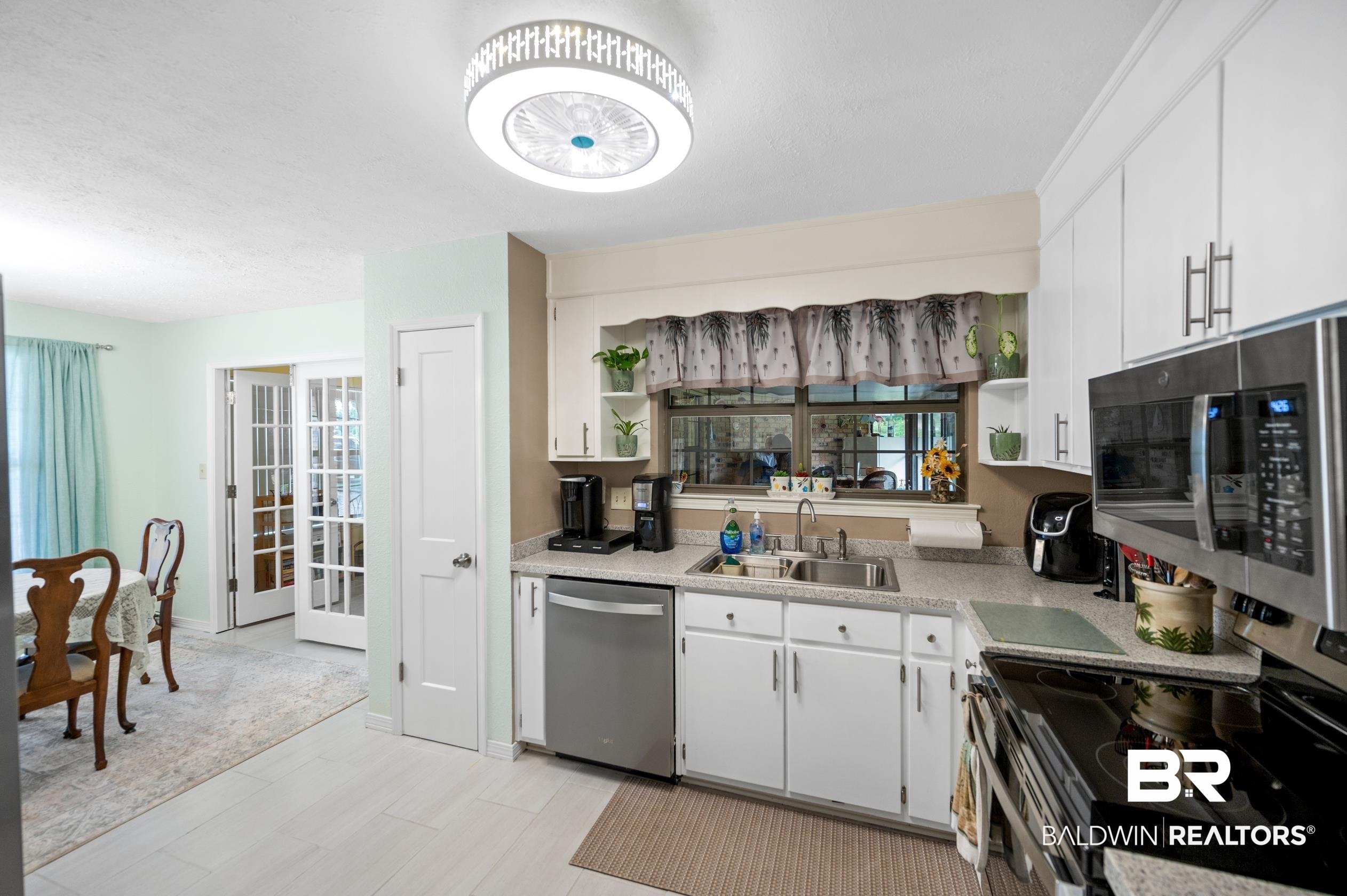 2772 Santa Rosa Circle Lillian, AL 36549 - Photo 12 of 50 Kitchen featuring white cabinetry, appliances with stainless steel finishes, and sink