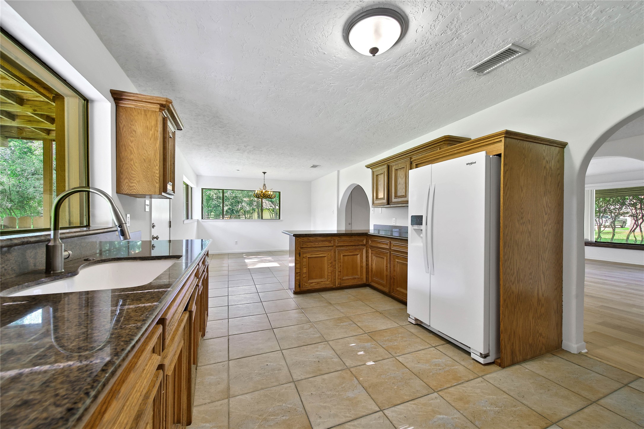 15418 Willis Way Conroe, TX 77384 - Photo 21 of 41 View from the back corner of the kitchen, front living room can be seen on the far right of the picture. Fridge conveys.