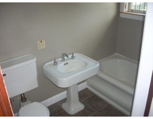 310 Pine Street Springfield, MA 01105 - Photo 6 of 6 a white sink sitting under a bathroom mirror