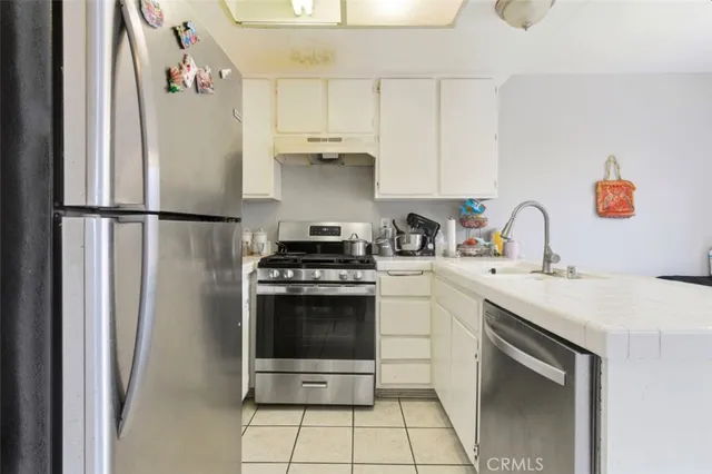 a kitchen with a sink cabinets and window