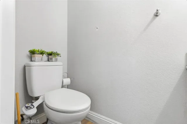 a bedroom with a large bed and a flat tv screen on dresser