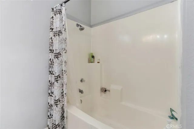 a view of a house with wooden fence