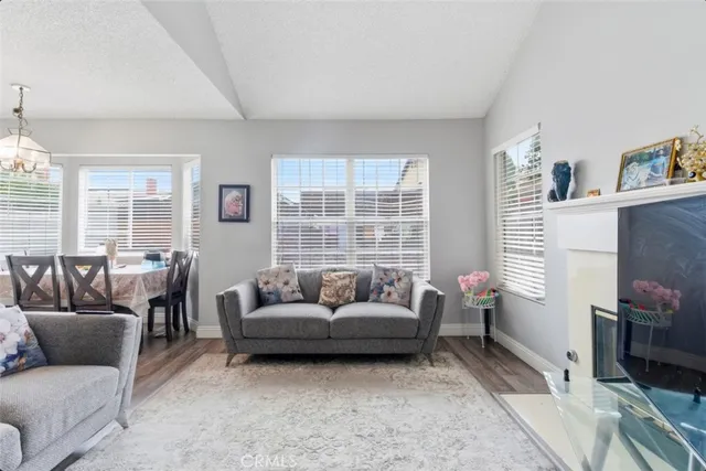 a living room with furniture a flat screen tv and a fireplace