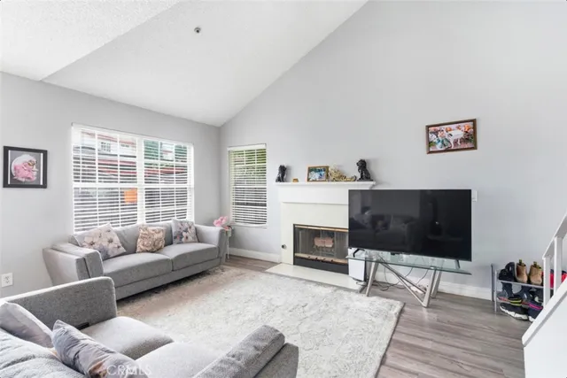 a dining room with furniture a chandelier and wooden floor