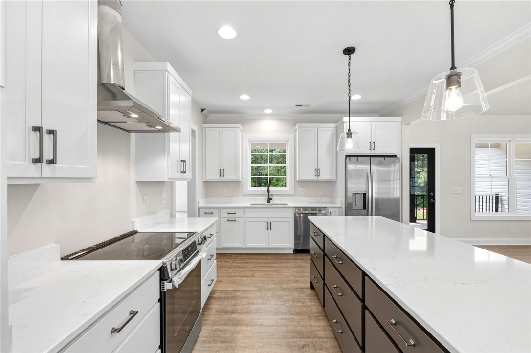 1735 Maw Bridge Road Central, SC 29630 - Photo 14 of 38 This modern kitchen features an expansive island, sleek stainless steel appliances, and ample cabinetry for all your culinary needs.