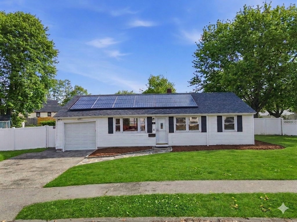 34 Beaconsfield Street Lawrence, MA 01843 - Photo 1 of 29 a view of a house with a yard