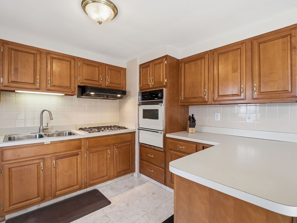 34 Beaconsfield Street Lawrence, MA 01843 - Photo 11 of 29 a kitchen with stainless steel appliances granite countertop a sink stove and refrigerator