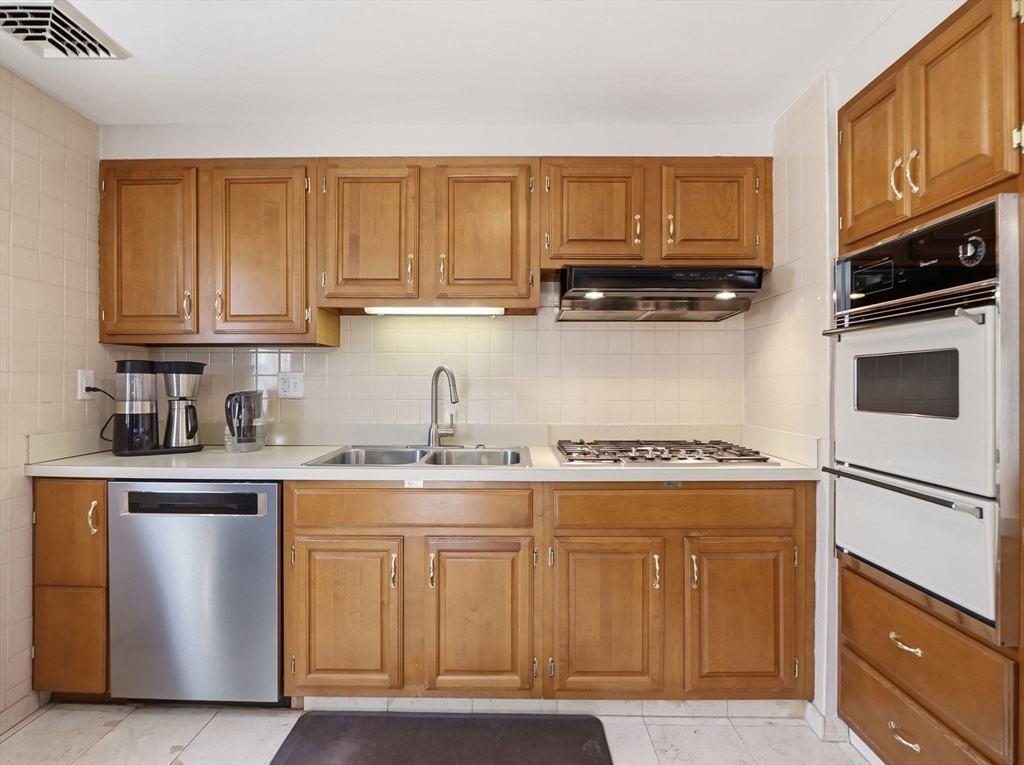 34 Beaconsfield Street Lawrence, MA 01843 - Photo 12 of 29 a kitchen with stainless steel appliances granite countertop a stove a sink and a microwave