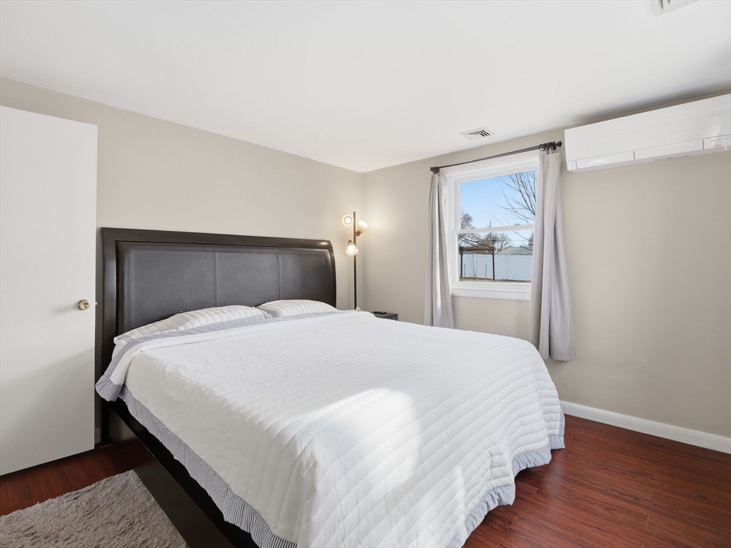 34 Beaconsfield Street Lawrence, MA 01843 - Photo 17 of 29 a bedroom with a bed and wooden floor