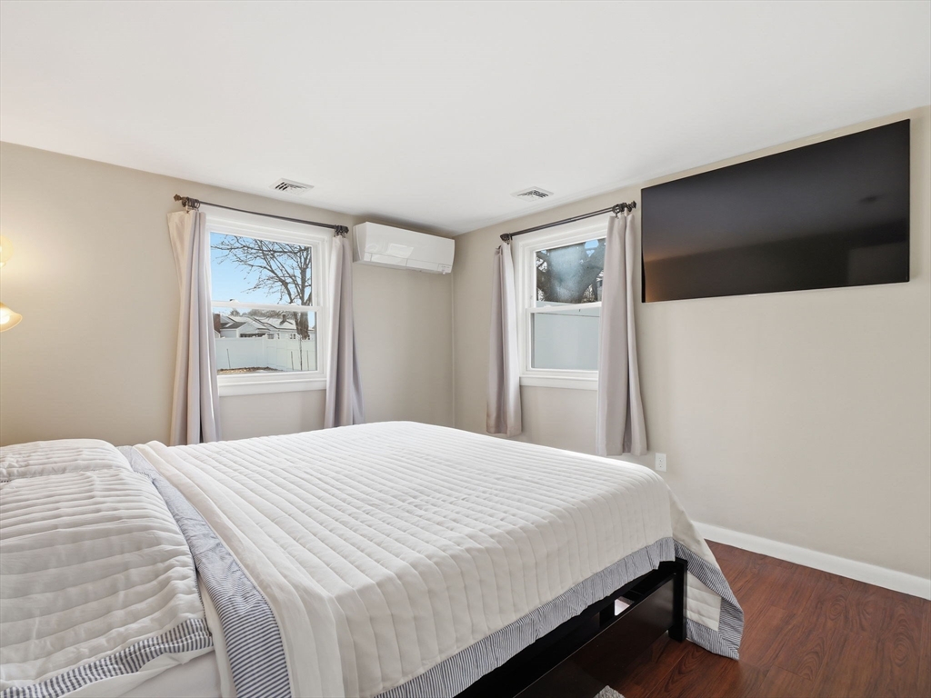 34 Beaconsfield Street Lawrence, MA 01843 - Photo 18 of 29 a bedroom with a large bed and a flat screen tv