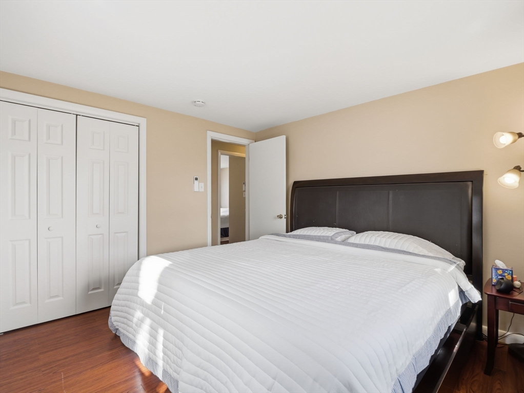 34 Beaconsfield Street Lawrence, MA 01843 - Photo 19 of 29 a bedroom with a bed and wooden floor