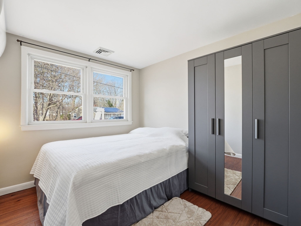34 Beaconsfield Street Lawrence, MA 01843 - Photo 23 of 29 a bedroom with a bed and wooden floor