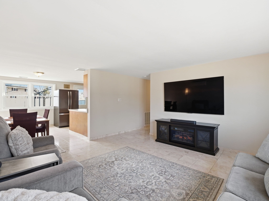34 Beaconsfield Street Lawrence, MA 01843 - Photo 6 of 29 a living room with furniture and a flat screen tv