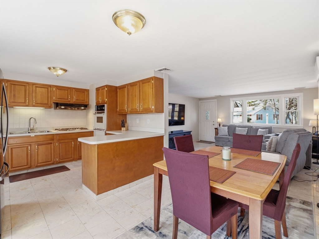 34 Beaconsfield Street Lawrence, MA 01843 - Photo 10 of 29 a view of a dining room with furniture and a kitchen view