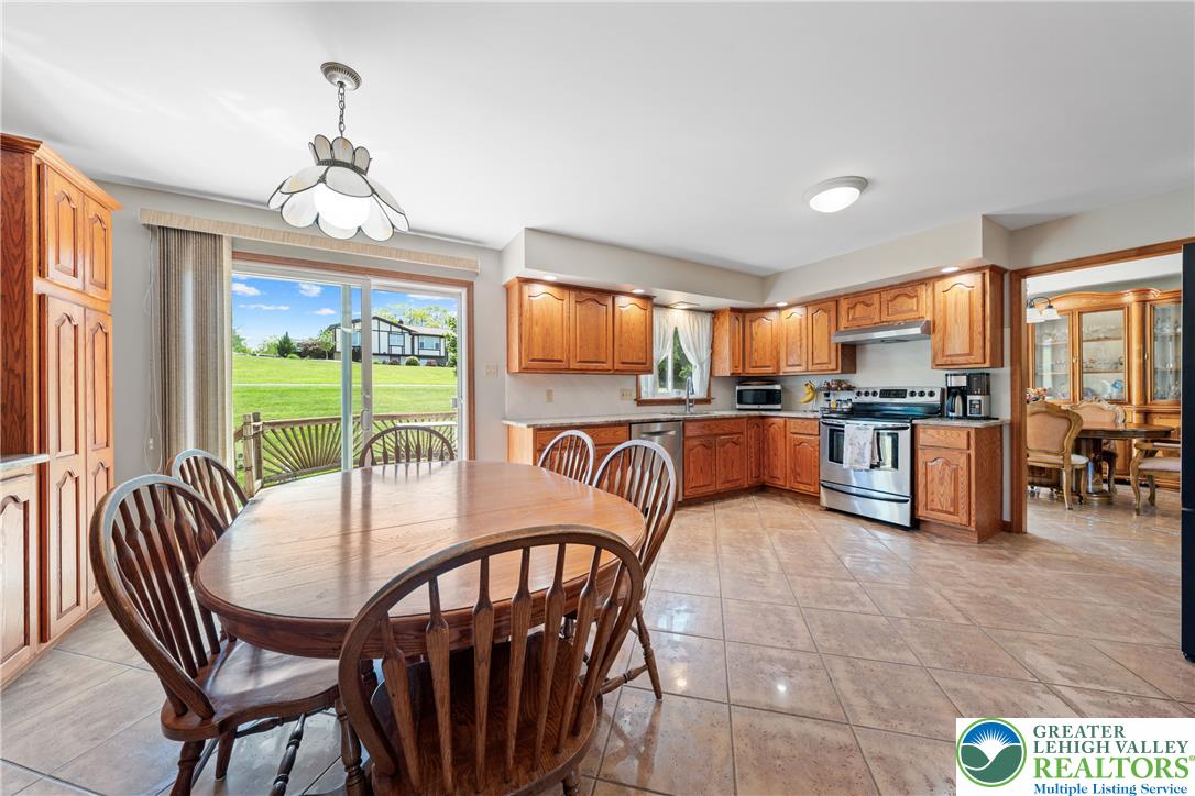 947 Tamenend Road Bath, PA 18014 - Photo 10 of 61 A well-lit kitchen with natural wood cabinetry and a view of the rolling green landscape.