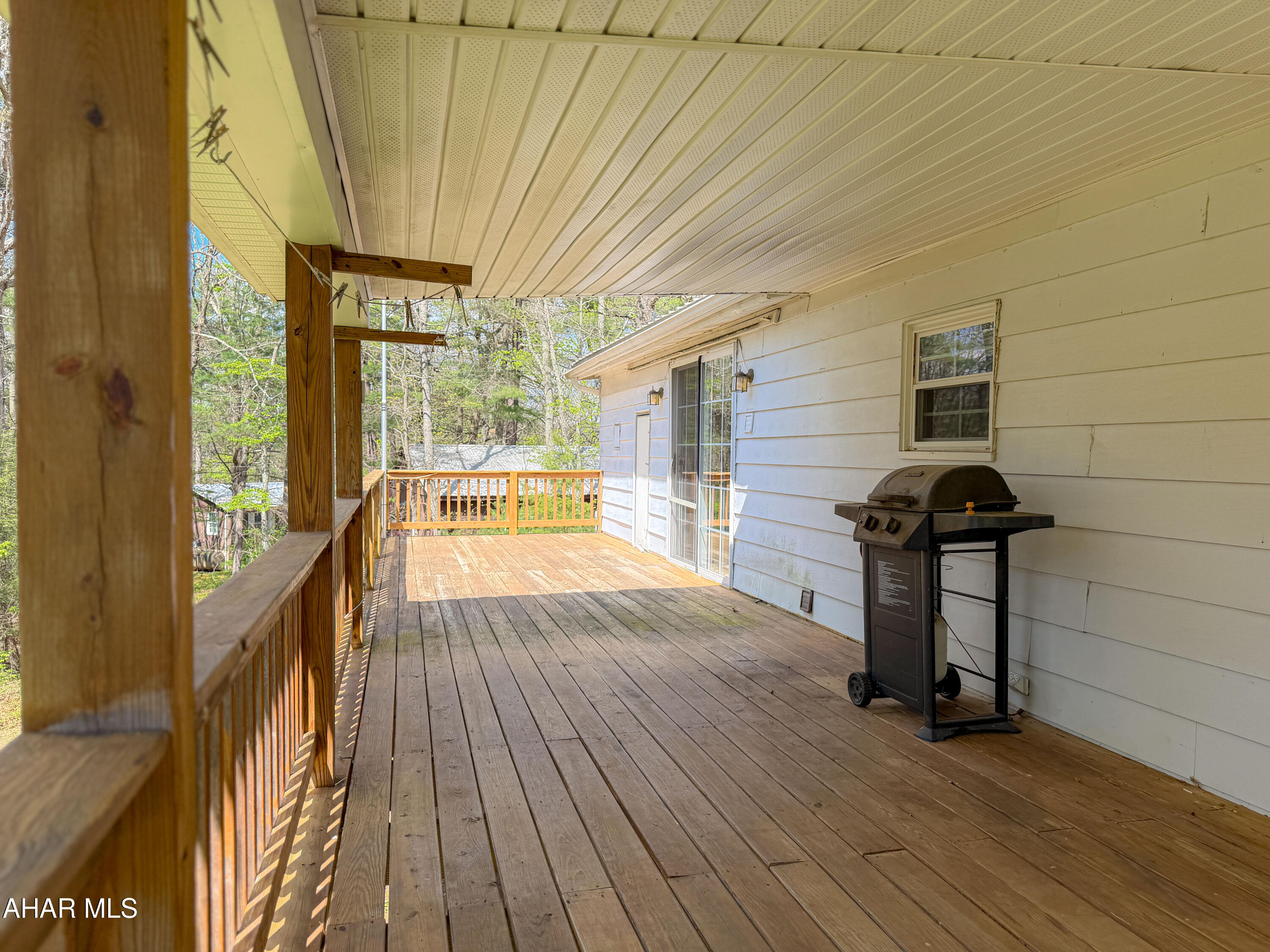 151 Pine Echo Road Everett, PA 15537 - Photo 3 of 51 a view of a porch with wooden floor and iron stairs