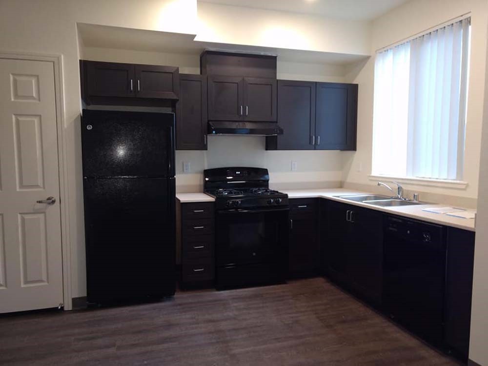 2300 Loveridge Road Pittsburg, CA 94565 - Photo 10 of 14 a kitchen with granite countertop stainless steel appliances and wooden cabinets