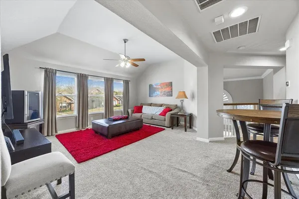 a bedroom with furniture and a wooden floor