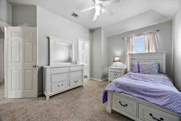 a bedroom with a bed and a dresser