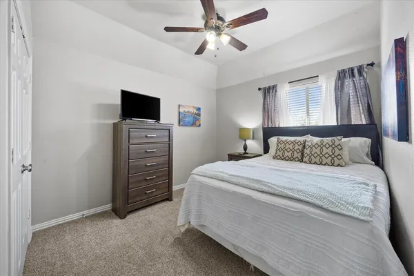 a bedroom with a bed and a television