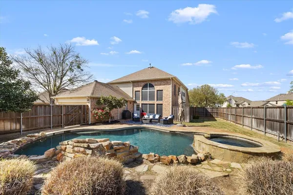 a view of a house with swimming pool and sitting area