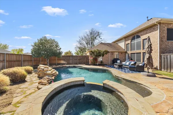 a backyard of a house with table and chairs