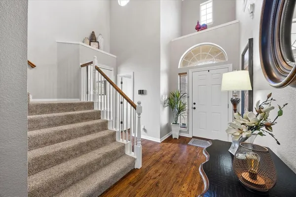 a view of hall way with furniture and wooden floor
