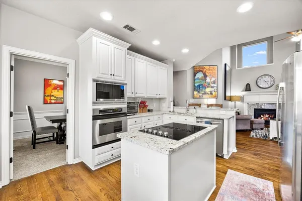 a kitchen with a stove cabinets and a sink
