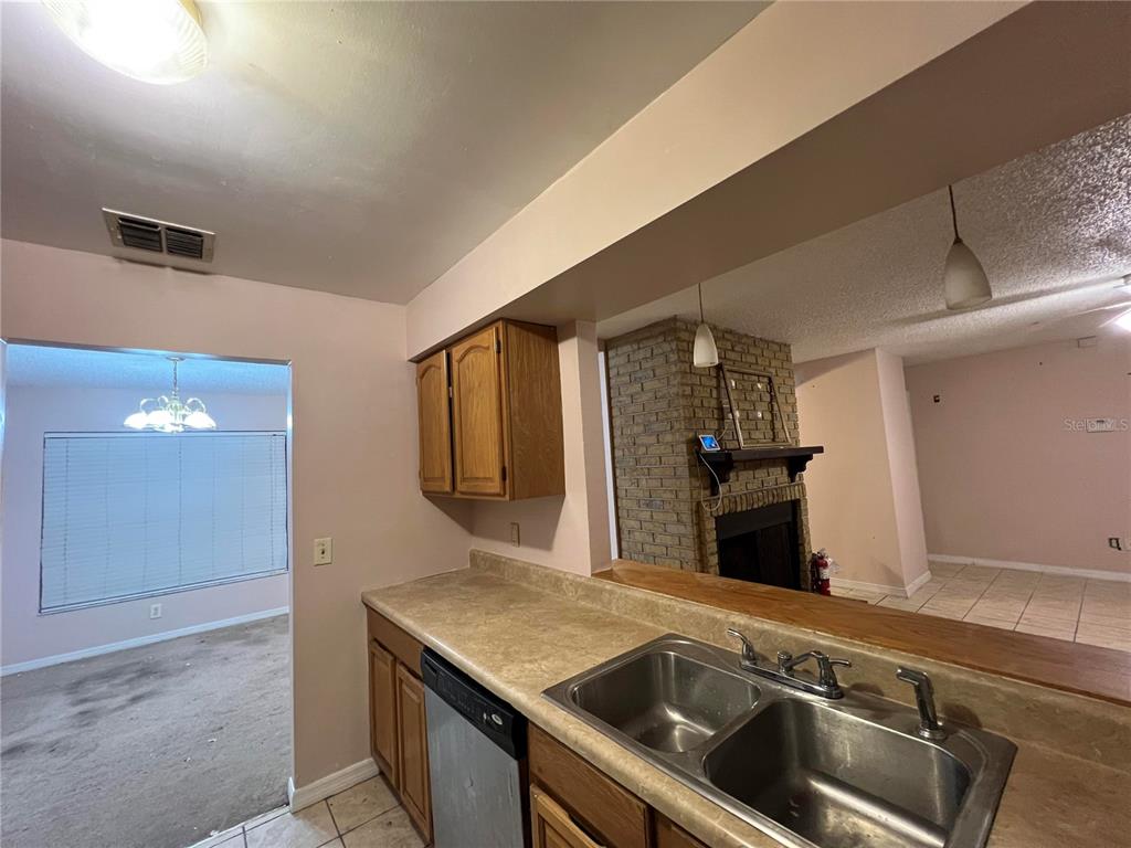 5411 Myrica Road Orlando, FL 32810 - Photo 11 of 26 a kitchen with a sink and a refrigerator