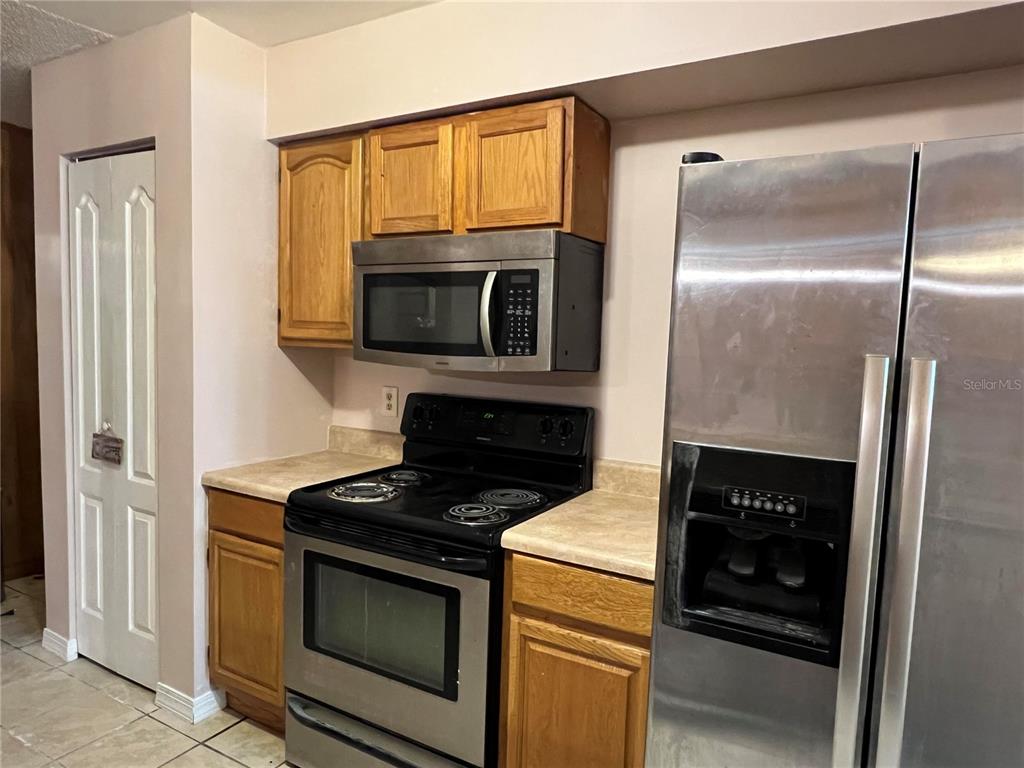 5411 Myrica Road Orlando, FL 32810 - Photo 12 of 26 a kitchen with a stove and a microwave