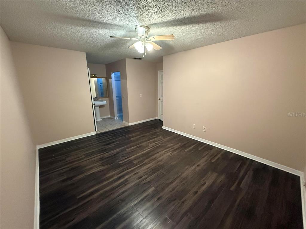 5411 Myrica Road Orlando, FL 32810 - Photo 15 of 26 a view of an empty room with wooden floor
