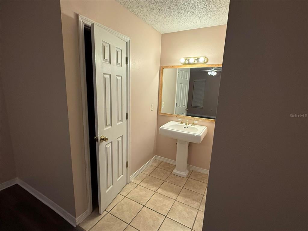 5411 Myrica Road Orlando, FL 32810 - Photo 16 of 26 a bathroom with a sink a toilet and a mirror