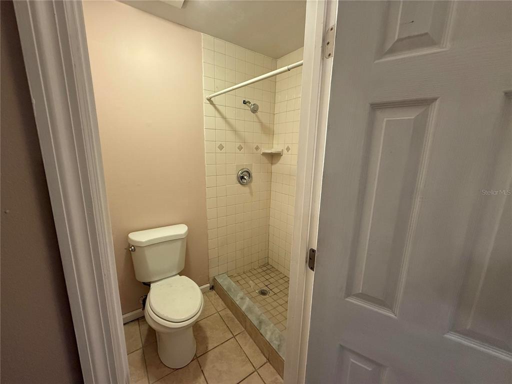 5411 Myrica Road Orlando, FL 32810 - Photo 17 of 26 a bathroom with a toilet and a shower