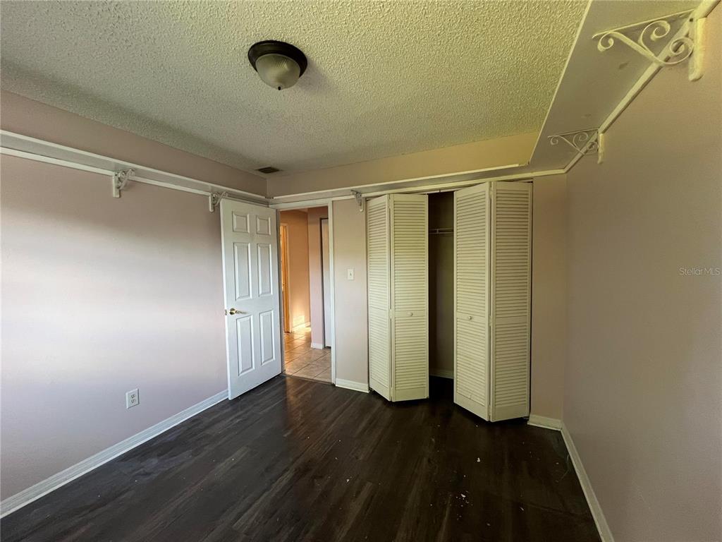 5411 Myrica Road Orlando, FL 32810 - Photo 23 of 26 a view of an empty room with wooden floor and a window