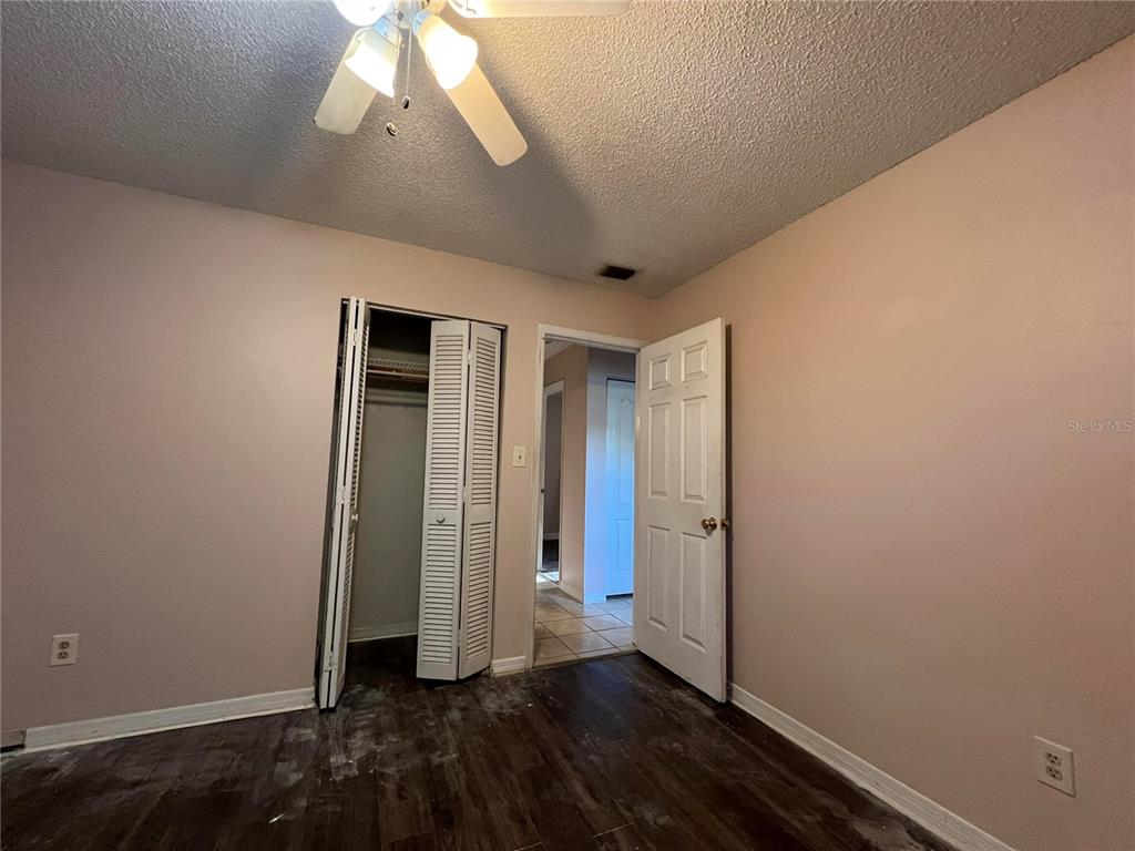 5411 Myrica Road Orlando, FL 32810 - Photo 26 of 26 an empty room with wooden floor and windows