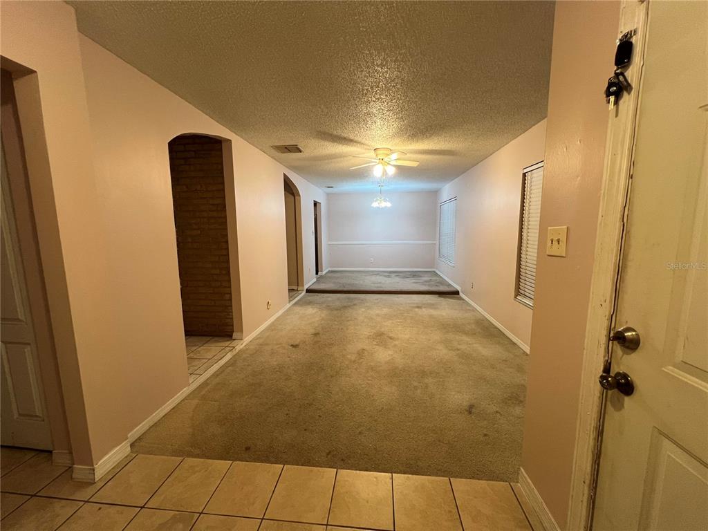 5411 Myrica Road Orlando, FL 32810 - Photo 5 of 26 a view of a hallway with painted walls