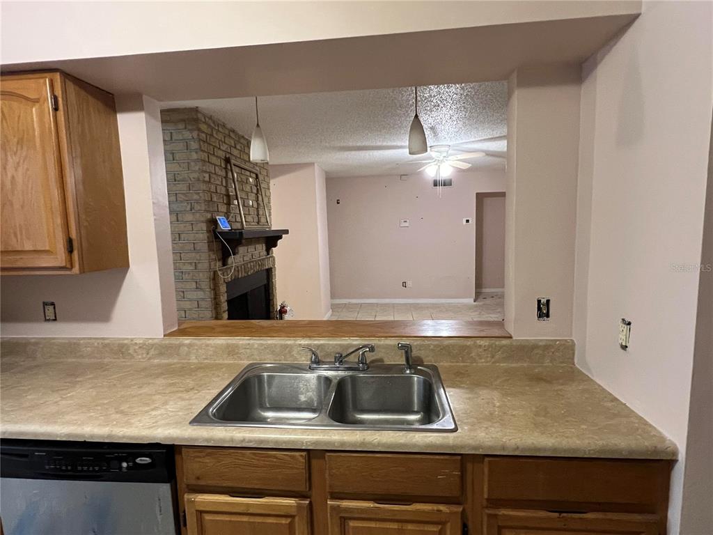 5411 Myrica Road Orlando, FL 32810 - Photo 9 of 26 a kitchen with a sink and cabinets