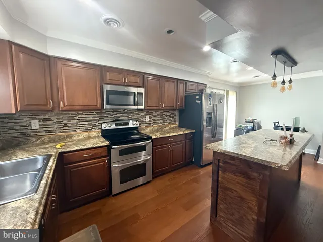 a kitchen with a sink stove and refrigerator